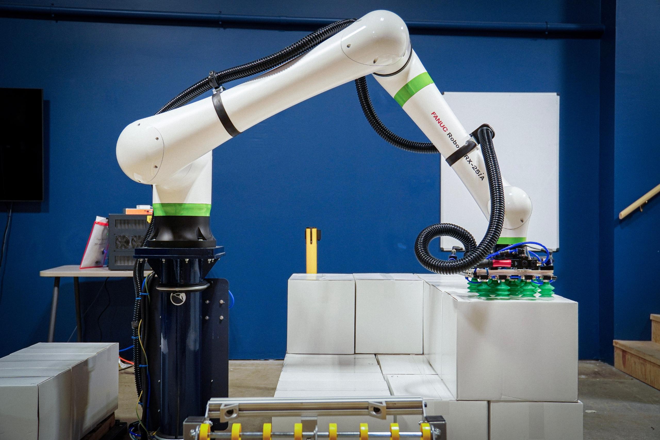 Robot Palletizing boxes from a conveyor onto a pallet.