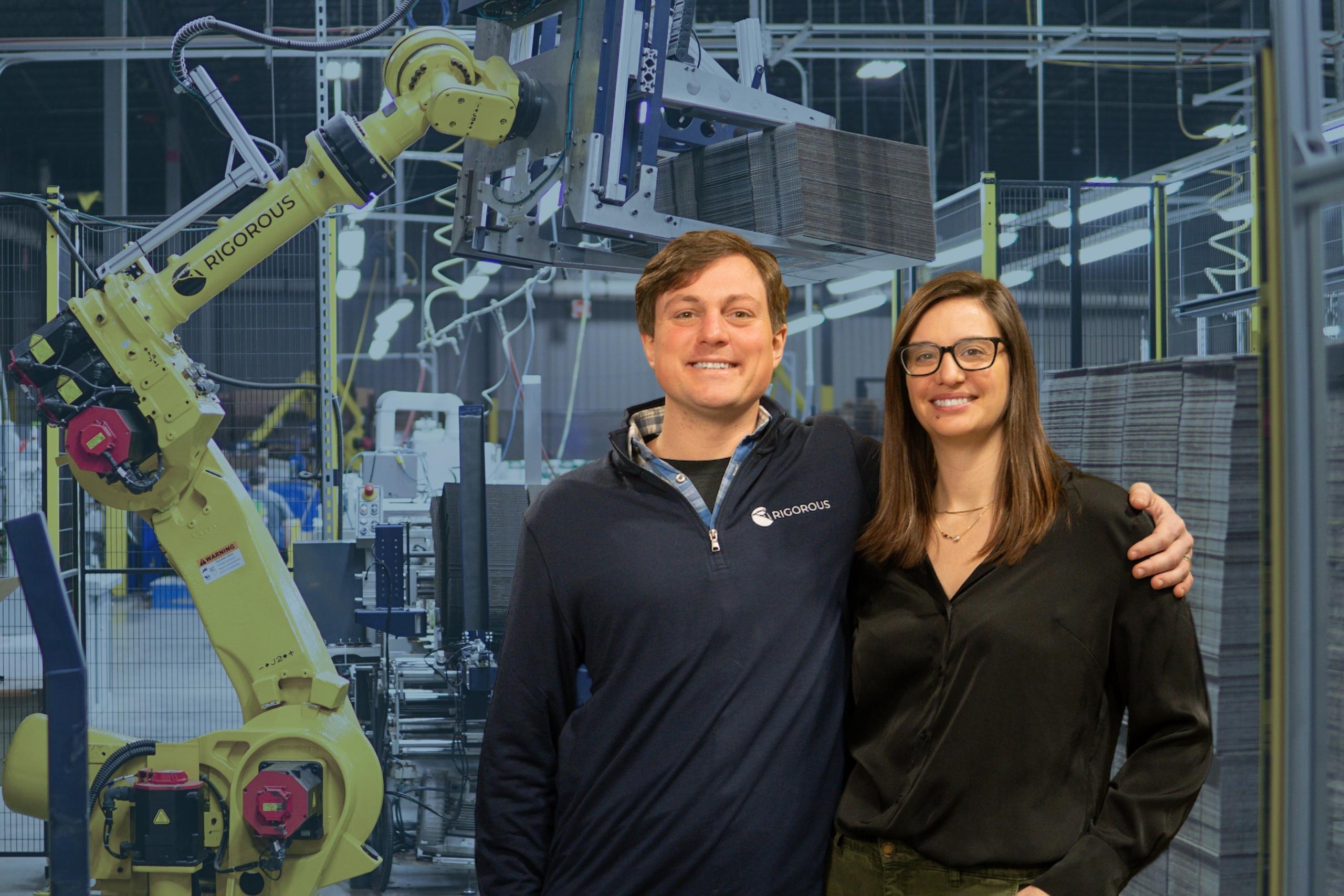 Co-Founders posing with Fanuc robot.